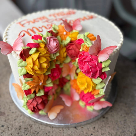 Decorative cut cake with colorful floral designs 