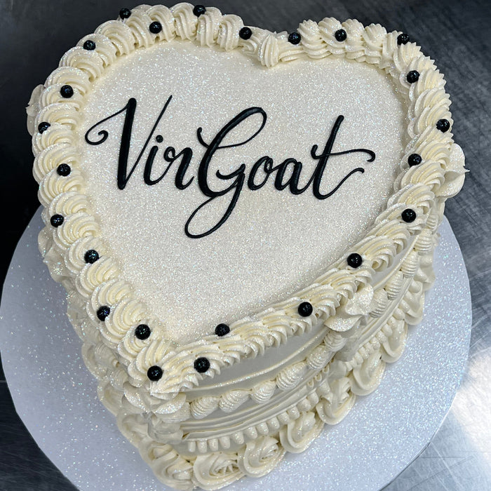 heart shaped cake with white and black icing