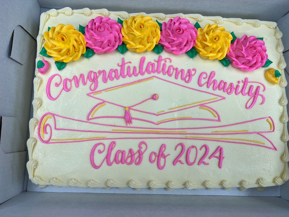 Graduation-themed sheet cake with pink and yellow large flowers 