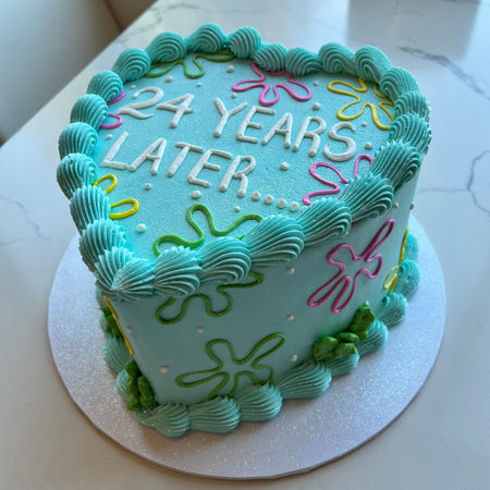 Heart-shaped Anniversary cake with '24 Years Later' text 