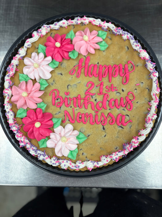 chocolate chip naked cookie cake with pink and red petal flowers. child or adult birthday