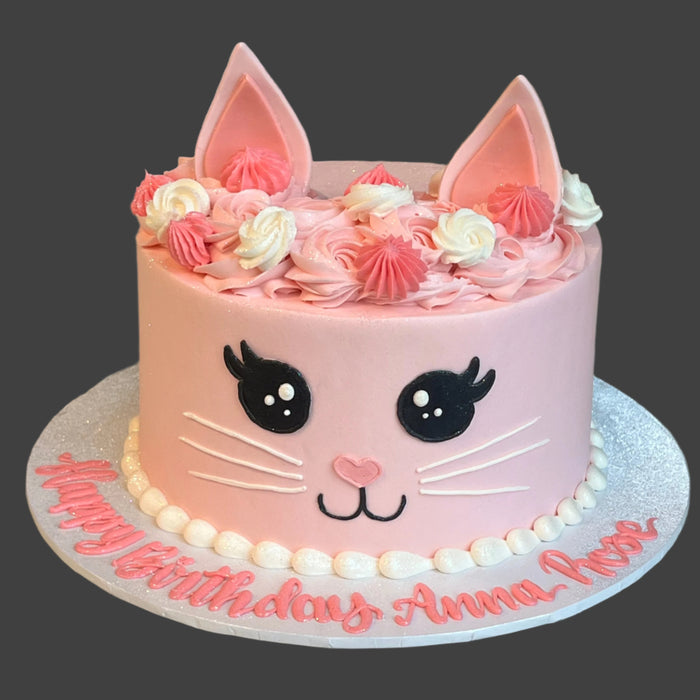 round kitty birthday cake with pink icing and fondant ears and eyes. child or adult birthday
