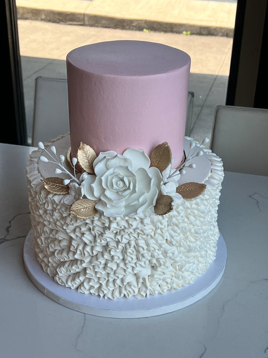 2 tier wedding cake white ruffled bottom blush top white rose