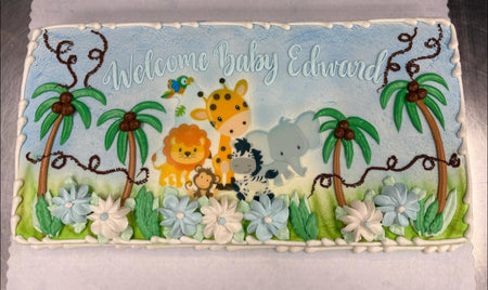 Decorative birthday cake with jungle animals  on a blue background.