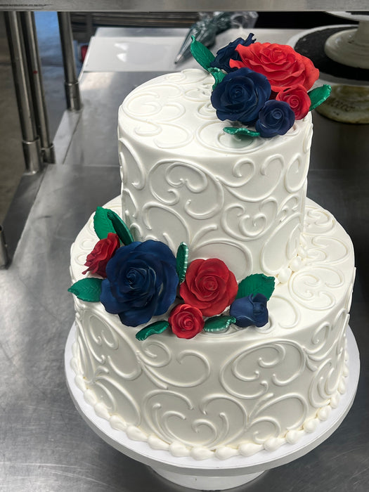 2 tier wedding cake with blue and red roses