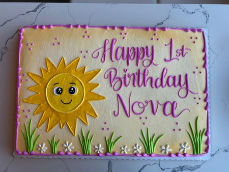 Happy 1st birthday cake with a sun design and personalized text 