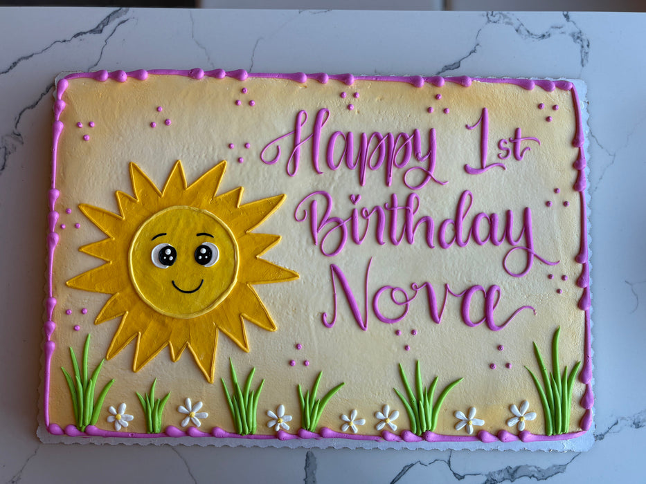 Happy 1st birthday cake with a sun design and personalized text 