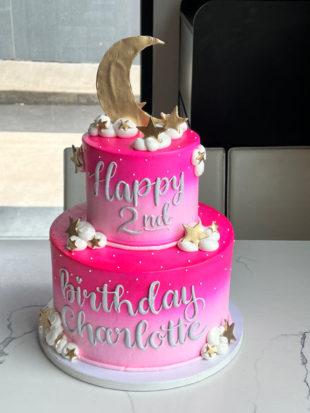 2 tier 2nd birthday cake with pink ombre icing and a moon on top