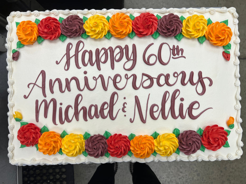 Anniversary sheet cake with orange, red and yellow flowers